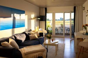 a living room with a couch and a table at Sonnenkoje in Fehmarn