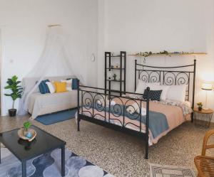 a bedroom with a bed and a couch at ON THE SAND apartment in Artemida
