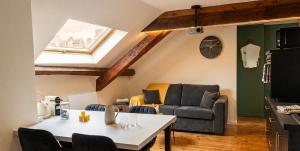 a living room with a table and a couch at le petit château in Chambéry