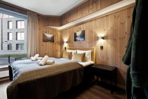 a bedroom with a bed with two teddy bears on it at Fyri Resort Nr 23 in Hemsedal