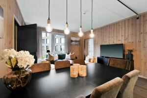a dining room with a table and a living room at Fyri Resort Nr 23 in Hemsedal