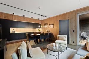 a living room with a table and a dining room at Fyri Resort Nr 23 in Hemsedal