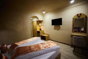 a hotel room with two beds and a television at Hotel Old Heritage in Tashkent