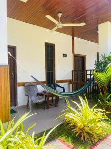 a hammock in the middle of a porch at Baywings Rooms in Arugam Bay +36 photos