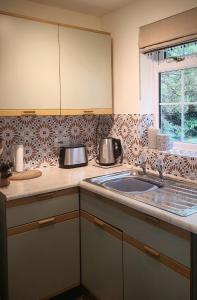 a kitchen counter with a sink and a window at Apple Tree View in Coulston +3 photos