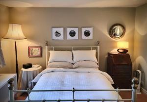 a bedroom with a bed and two pictures on the wall at Apple Tree View in Coulston