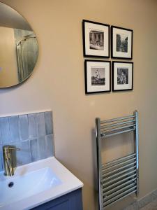 a bathroom with a sink and a mirror at Apple Tree View in Coulston