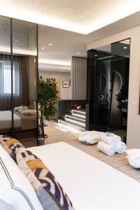 a bedroom with a bed and a large mirror at Easter Suites Luxury - Signature Stays in Monopoli in Monopoli