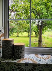a window with two vases sitting on top of a counter at Apple Tree View in Coulston