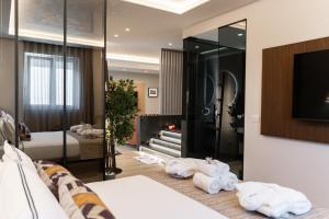a room with a bed and a tv and a bedroom at Easter Suites Luxury - Signature Stays in Monopoli in Monopoli