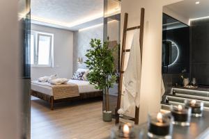 a bedroom with a bed and a potted plant at Easter Suites Luxury - Signature Stays in Monopoli in Monopoli