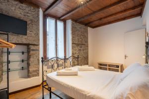 a bedroom with a bed and a tub in a room at Historic Borgo Lake Como Campidoglio 5 in Lenno +52 photos