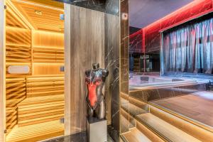 a bathroom with a statue of a woman on the wall at Int 37 Luxury Rooms in Rome +24 photos