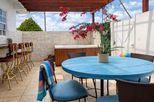 a patio with a blue table and chairs at Villa Fina Aruba in Palm-Eagle Beach