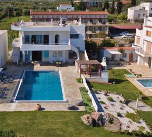 an aerial view of a villa with a swimming pool at Antorina Beachfront Villas with Private Pools in Kamárion