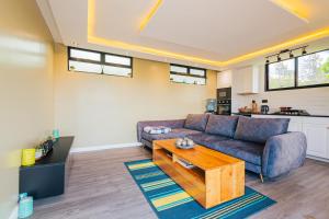 a living room with a couch and a coffee table at Oaklands Tin Nest in Ruiru