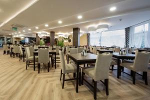 a dining room with tables and chairs in a restaurant at Hotel *** NAT Ustroń in Ustroń