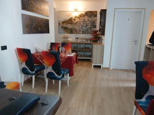 a dining room with a red table and chairs at Casa Carlotta in Perledo
