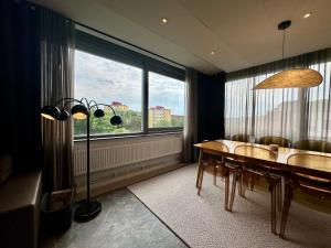 a dining room with a table and chairs and a large window at Spar Hotel Majorna in Gothenburg