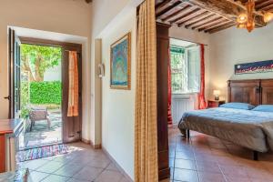 a bedroom with a bed and a door to a patio at Casa Anita Lucca in Lucca +47 photos