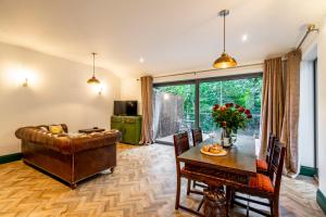 a living room with a couch and a table at Tawny Lodge in York