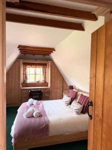 a bedroom with a large bed in a attic at Mesopotamia Cottage in Clifton Hampden