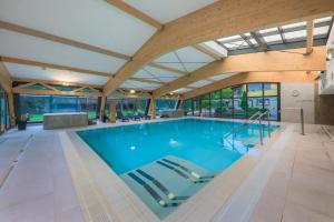 a large swimming pool with a large ceiling at Hotel *** NAT Ustroń in Ustroń