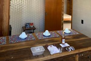 a wooden table with a bottle of wine on it at Pousada Mar Vintage in Laguna +63 photos