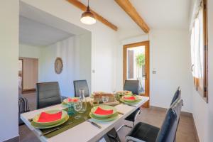 a dining room with a table with plates of food on it at Gite en sud-ardèche avec jacuzzi in Joyeuse