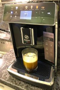 a cup of coffee sitting on a laptop in a microwave at Appartement im Park in Minusio