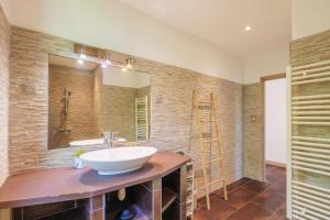 a bathroom with a sink and a mirror at Gite en sud-ardèche avec jacuzzi in Joyeuse +23 photos