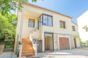 an image of a house with a garage at Gite en sud-ardèche avec jacuzzi in Joyeuse