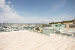 a large deck with a marina with boats at Marina di Scarlino Follonica Vista Mare in Puntone di Scarlino