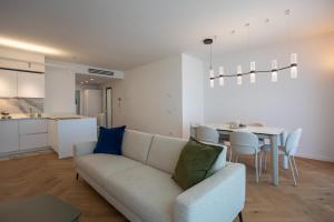 a living room with a couch and a table at Marina di Scarlino Follonica Vista Mare in Puntone di Scarlino