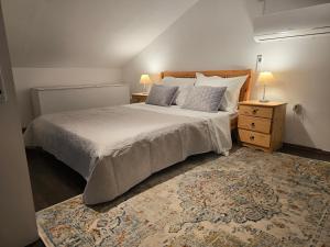 a bedroom with a bed with two pillows and a rug at Artisana Silba in Silba