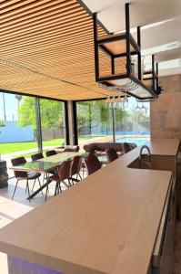 a dining room with a table and chairs and windows at Villa Paraíso in Seville