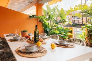 a table with a bottle of wine and food on it at ALOJAMIENTO ARENAL PARK in Jávea