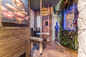 a room with a table and a painting on the wall at Int 37 Luxury Rooms in Rome