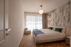 a bedroom with a bed and a large window at Marina di Scarlino Follonica Vista Mare in Puntone di Scarlino