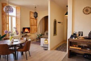 a dining room and living room with a table and a fireplace at SLEEP INN ANTWERP - Short & Longterm rentals in Antwerp