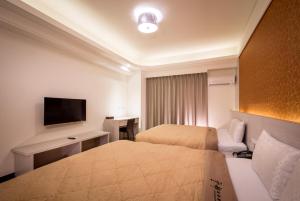 Ένα ή περισσότερα κρεβάτια σε δωμάτιο στο Yundu Business Hotel