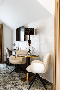 a dining room with a table and chairs at KQC Boutique Villa in Balatonlelle