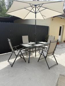 a table and chairs with an umbrella on a patio at Casa TeoMar in Brad