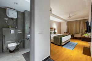 a hotel room with a bed and a bathroom at The Lohias Premium - Delhi IGI Airport in New Delhi +17 photos