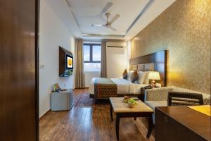 a hotel room with a bed and a couch at The Lohias Premium - Delhi IGI Airport in New Delhi