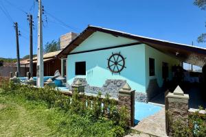 a house with a pool in front of it at Pousada Mar Vintage in Laguna
