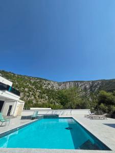a swimming pool in front of a house at The Bunica Residence in Parila