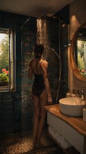 a woman standing in a bathroom next to a sink at Balaton Corner in Siófok +27 photos