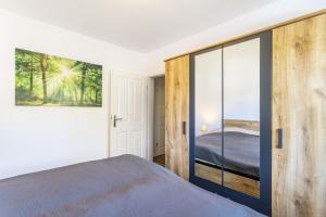 a bedroom with a bed and a sliding glass door at Ferienwohnung Landblick in Brilon