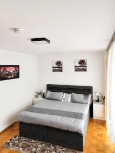 a bedroom with a large bed and white walls at Ferienhaus Magnolie in Eschwege